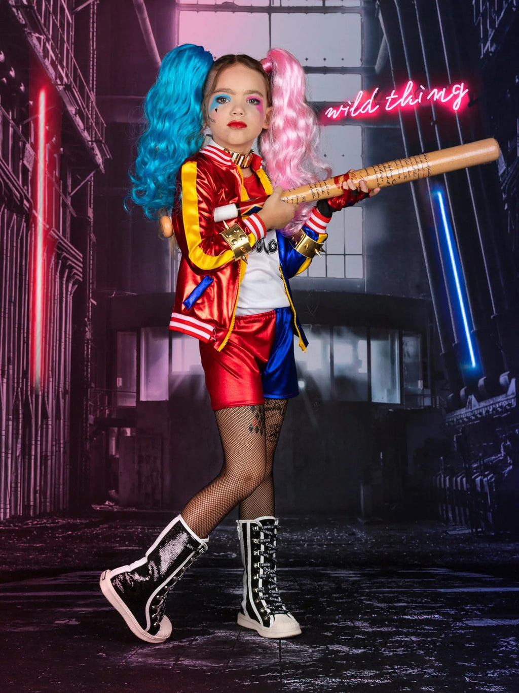 Girl's Harley Quinn costume set featuring red and blue jacket, matching shorts, two-tone wig, bat accessory, fishnet tights, and complete cosplay accessories.