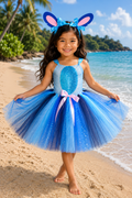 Stitch-inspired blue tutu dress for girls with sparkly bodice, layered blue and navy tulle skirt, pink bow, and oversized character ear headband.