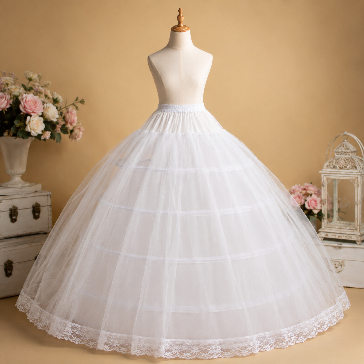 A white underbust skirt with a lace-trimmed hem displayed on a dress form mannequin against a warm beige background, with decorative flowers and vintage-style furniture in the scene.