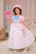 Girl wearing Little Bo Peep costume dress and matching hat for Halloween