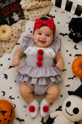 Pennywise inspired baby Halloween romper with gray ruffles, white lace collar and red pom pom details